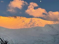 06A Lenin Peak shines orange at sunset with the moon above from Ak-Sai Travel Lenin Peak Camp 1 4400m